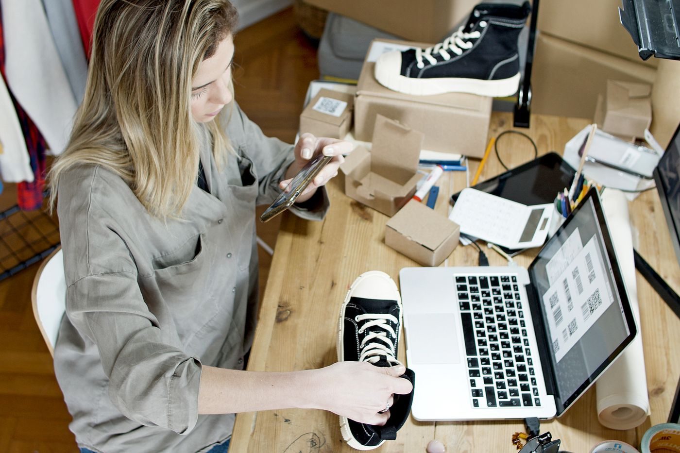 Small business owner packing product orders in a studio